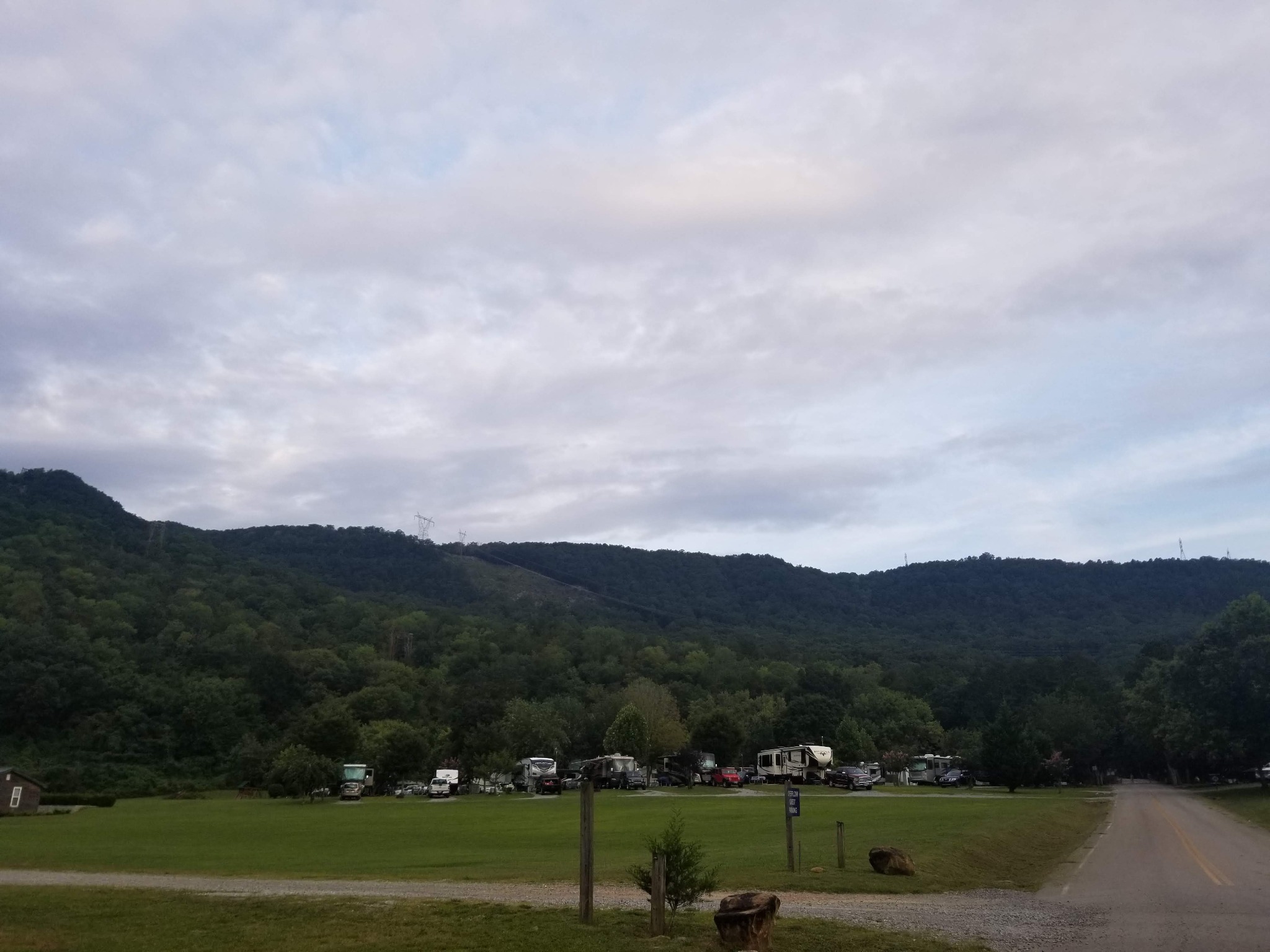 RV campsites beneath wooded mountains at Raccoon Mountain Campground