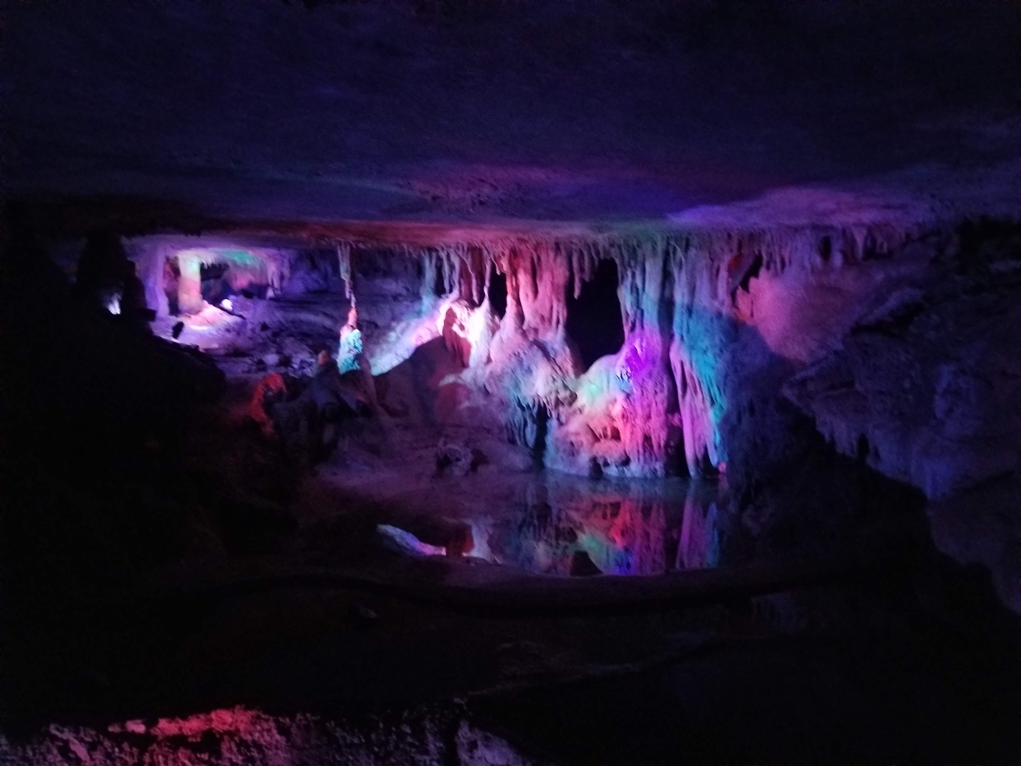 Cavern formations illuminated in purple and blue light