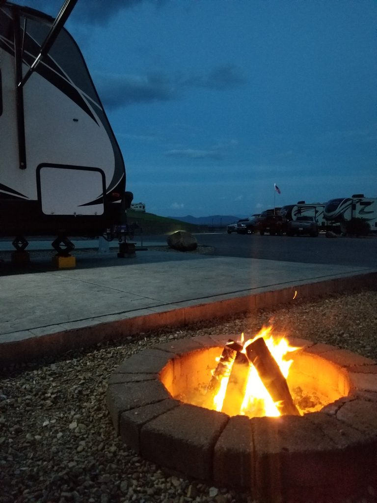 Campfire burning at an RV campsite at Anchor Down RV Resort in Tennessee